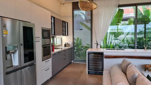 Modern kitchen with appliances and large windows