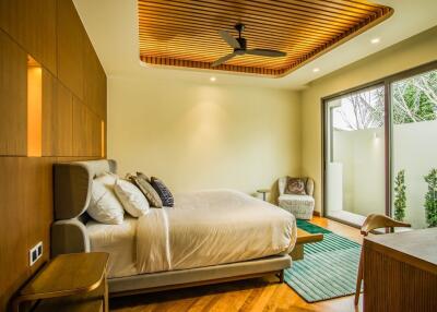 Modern bedroom with wooden ceiling accents and large glass doors