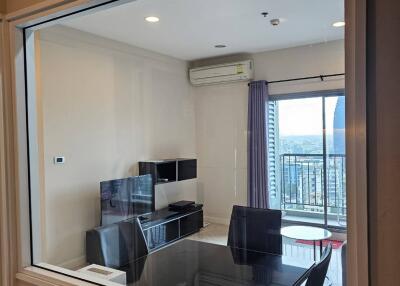 Modern living room with dining area and balcony view