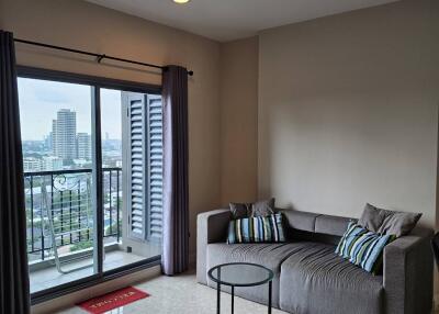 Bright living room with a large window and balcony