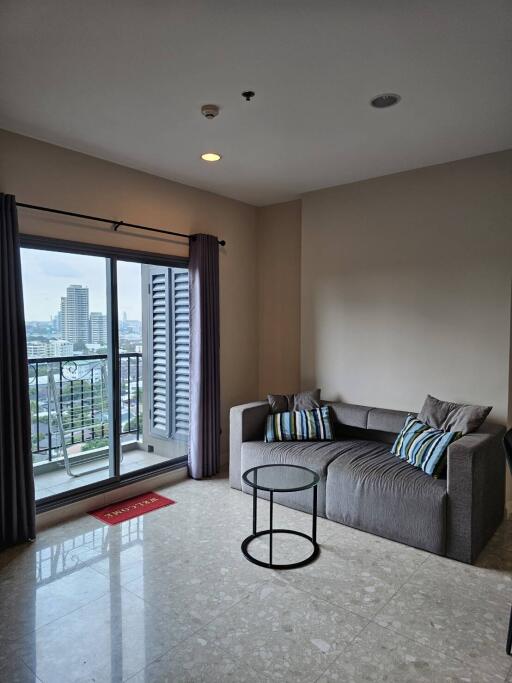 Bright living room with a large window and balcony