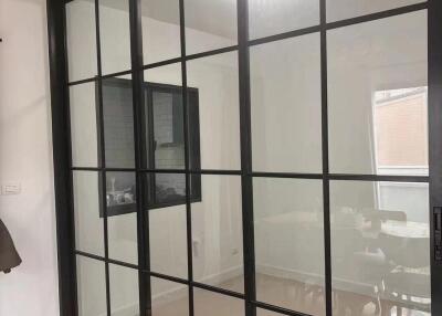 Glass partition separating two rooms