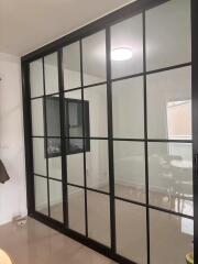 Glass partition separating two rooms