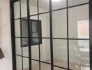 Glass partition separating two rooms