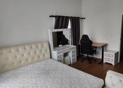 Bedroom with bed, dresser, and desk