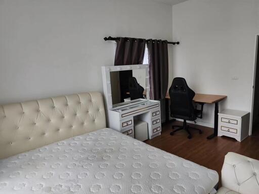 Bedroom with bed, dresser, and desk