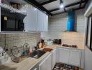 Modern kitchen with white cabinets and blue range hood