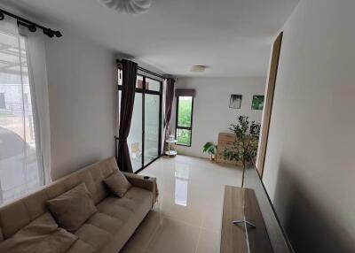 Spacious and modern living room with large windows and natural light.