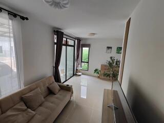 Spacious and modern living room with large windows and natural light.