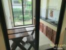 View of the kitchen with dining table and outdoor garden visible