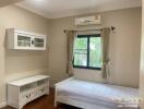 Bright bedroom with air conditioning and single bed