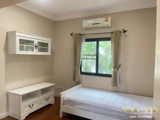 Bright bedroom with air conditioning and single bed