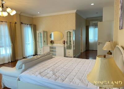 Spacious bedroom with a large bed and elegant decor