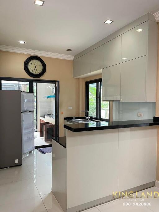 Modern kitchen with white cabinets and black countertops