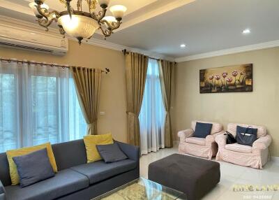 Well-furnished living room with a sofa, armchairs, coffee table, and elegant lighting