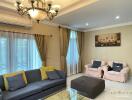 Well-furnished living room with a sofa, armchairs, coffee table, and elegant lighting