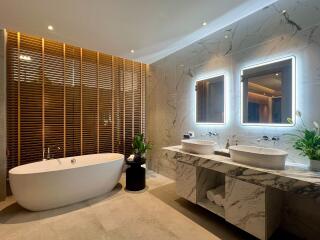 Modern bathroom with freestanding bathtub and double sinks