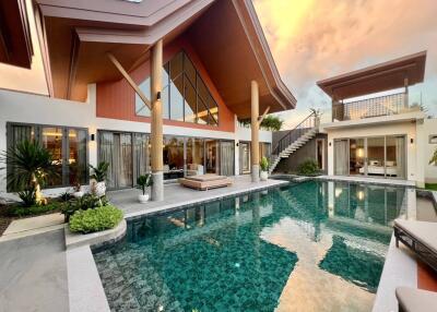 Modern house exterior with large swimming pool and outdoor seating area