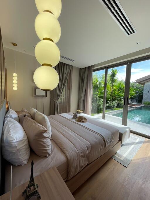 well-lit bedroom with poolside view