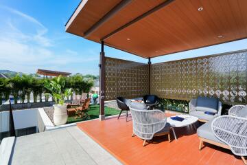 Modern outdoor seating area with lounge chairs and a covered pergola