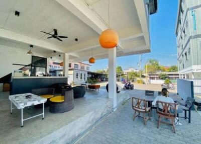 Spacious outdoor living area with seating and ceiling fans at a residential property