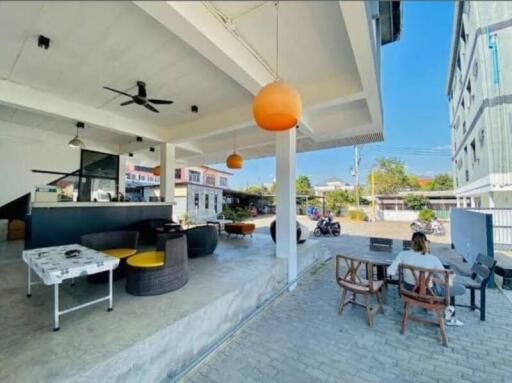 Spacious outdoor living area with seating and ceiling fans at a residential property