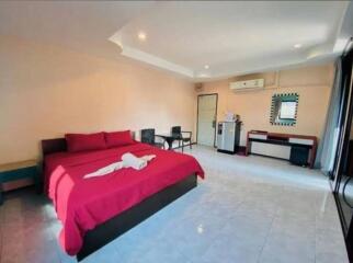 Spacious bedroom with double bed, air conditioning, and seating area