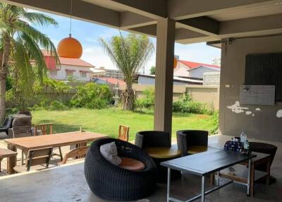 Spacious outdoor living area with modern furniture and tropical view