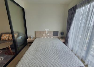 Modern bedroom with large window and access to balcony