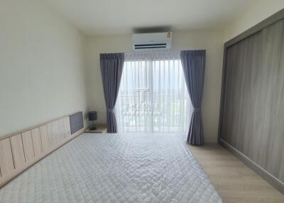 Modern bedroom with large window and air conditioning