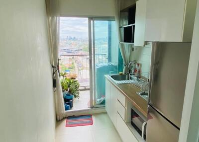 Compact kitchen with a balcony view