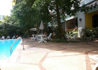 Swimming pool area with chairs and table