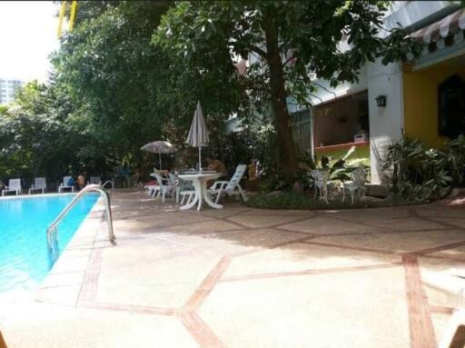 Swimming pool area with chairs and table