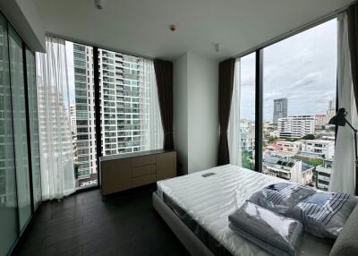 Modern bedroom with large windows and city view