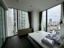 Modern bedroom with large windows and city view