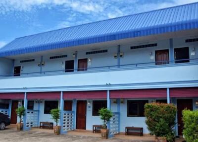 Two-story building with multiple entrances and a blue roof