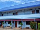 Two-story building with multiple entrances and a blue roof