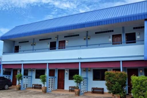 Two-story building with multiple entrances and a blue roof