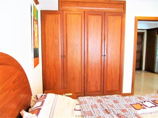 Bedroom with wooden wardrobe and bed