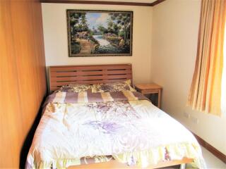 cozy bedroom with bed and colorful bedding