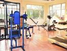 Well-equipped home gym with various exercise machines