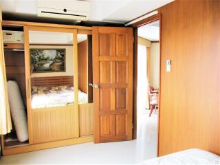 Bedroom with wooden door and built-in wardrobe