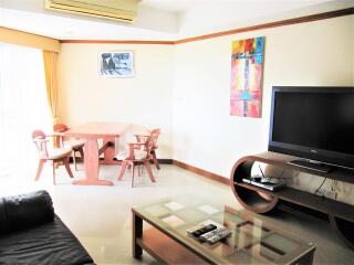 Living room with dining area and television