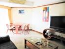 Living room with dining area and television