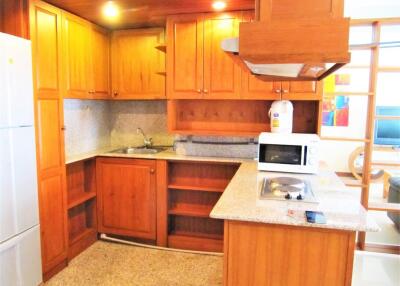 Wooden cabinetry kitchen with granite countertops