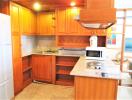 Wooden cabinetry kitchen with granite countertops