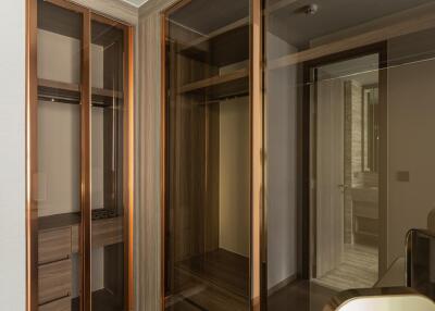 modern walk-in closet with glass doors