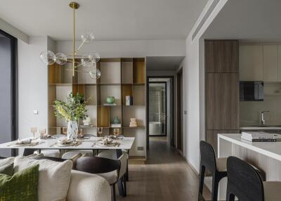 Modern dining area with table setup, shelving unit, and adjacent kitchen