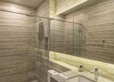 Modern bathroom with glass shower and large mirror