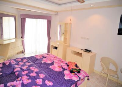 Bright and cozy bedroom with purple floral bedding and ample storage